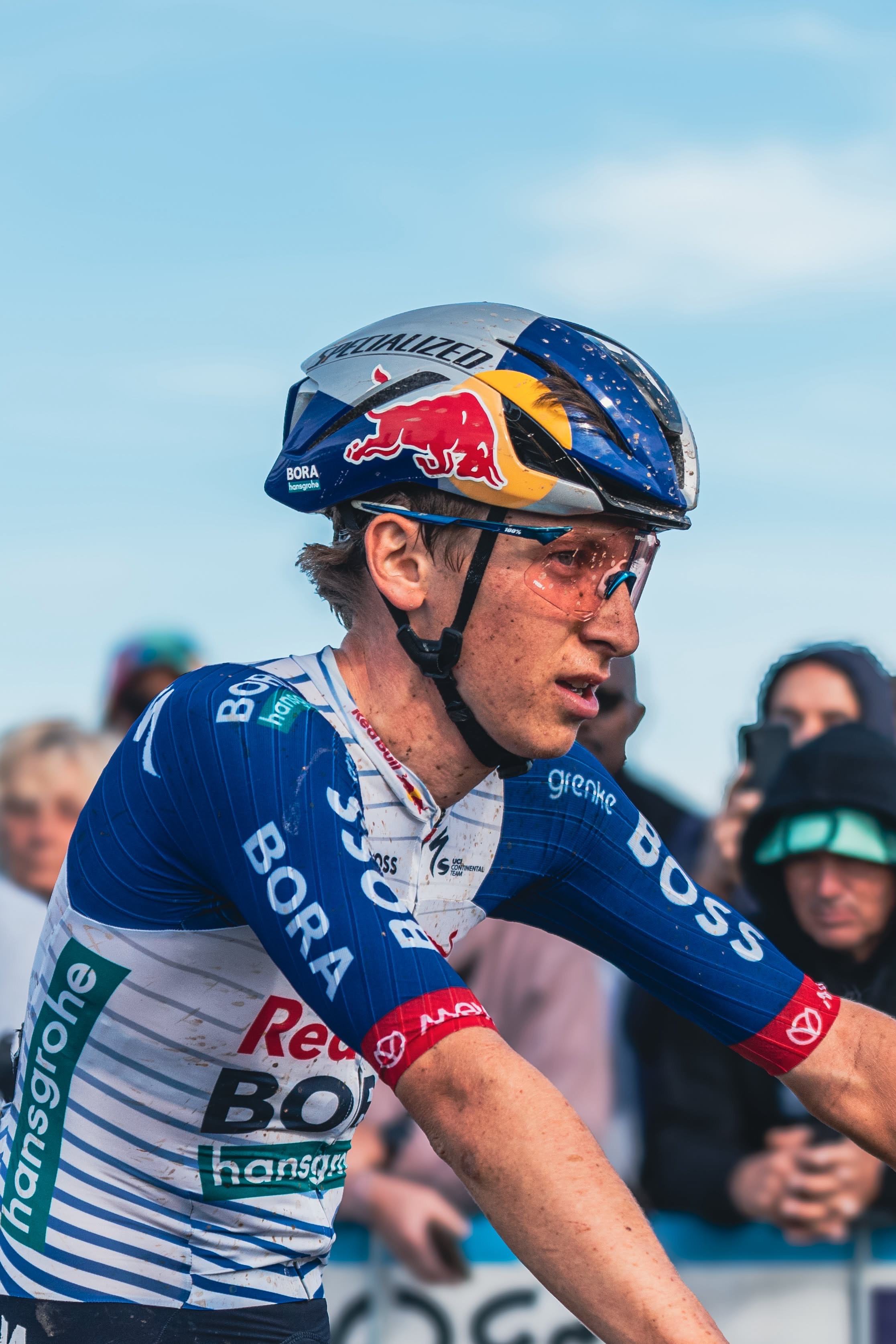 Portrait of Gustave Blanc in Red Bull helmet and Red Bull – BORA – hansgrohe Rookies jersey at a race start